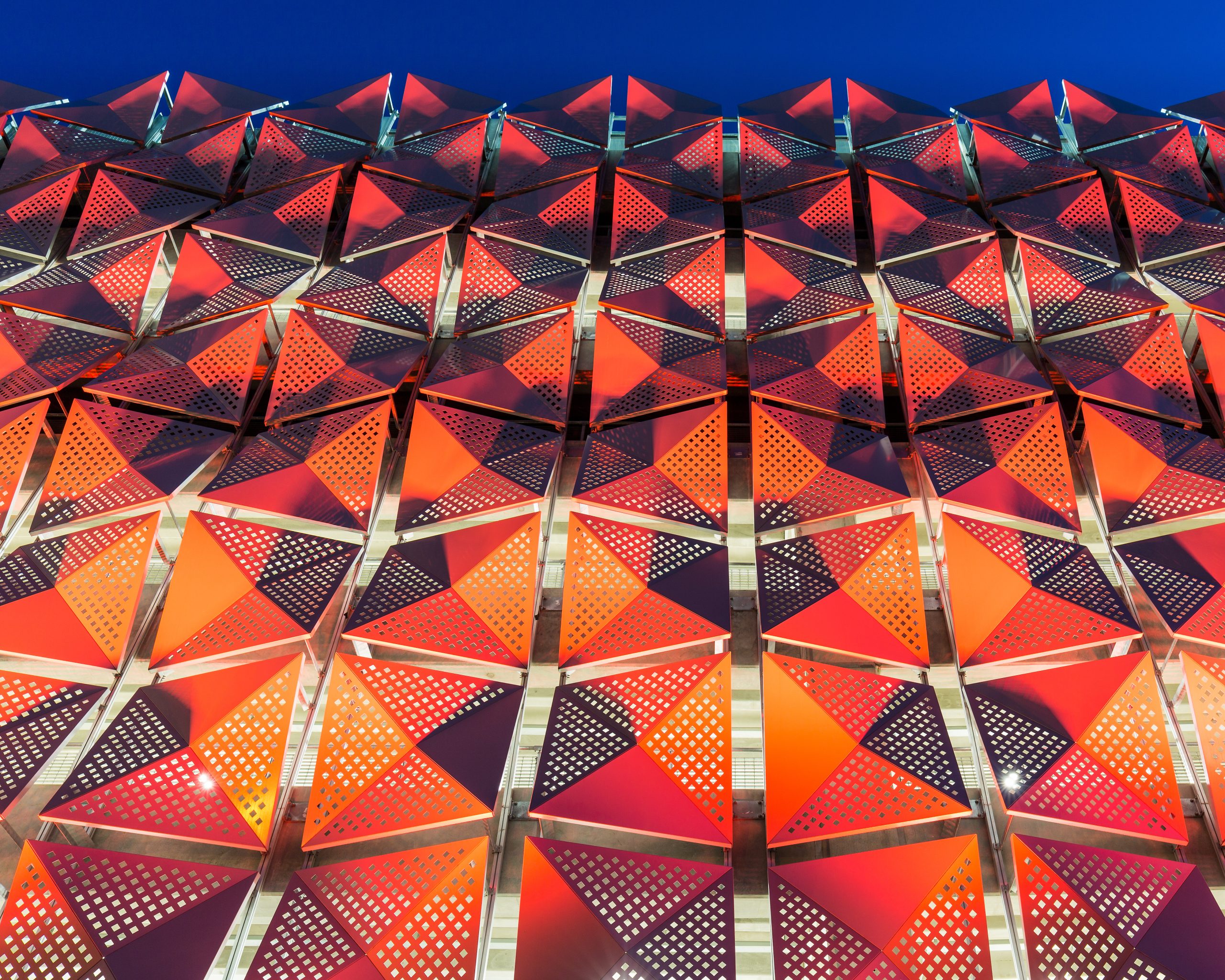 Abstract geometric red and orange patterned facade.