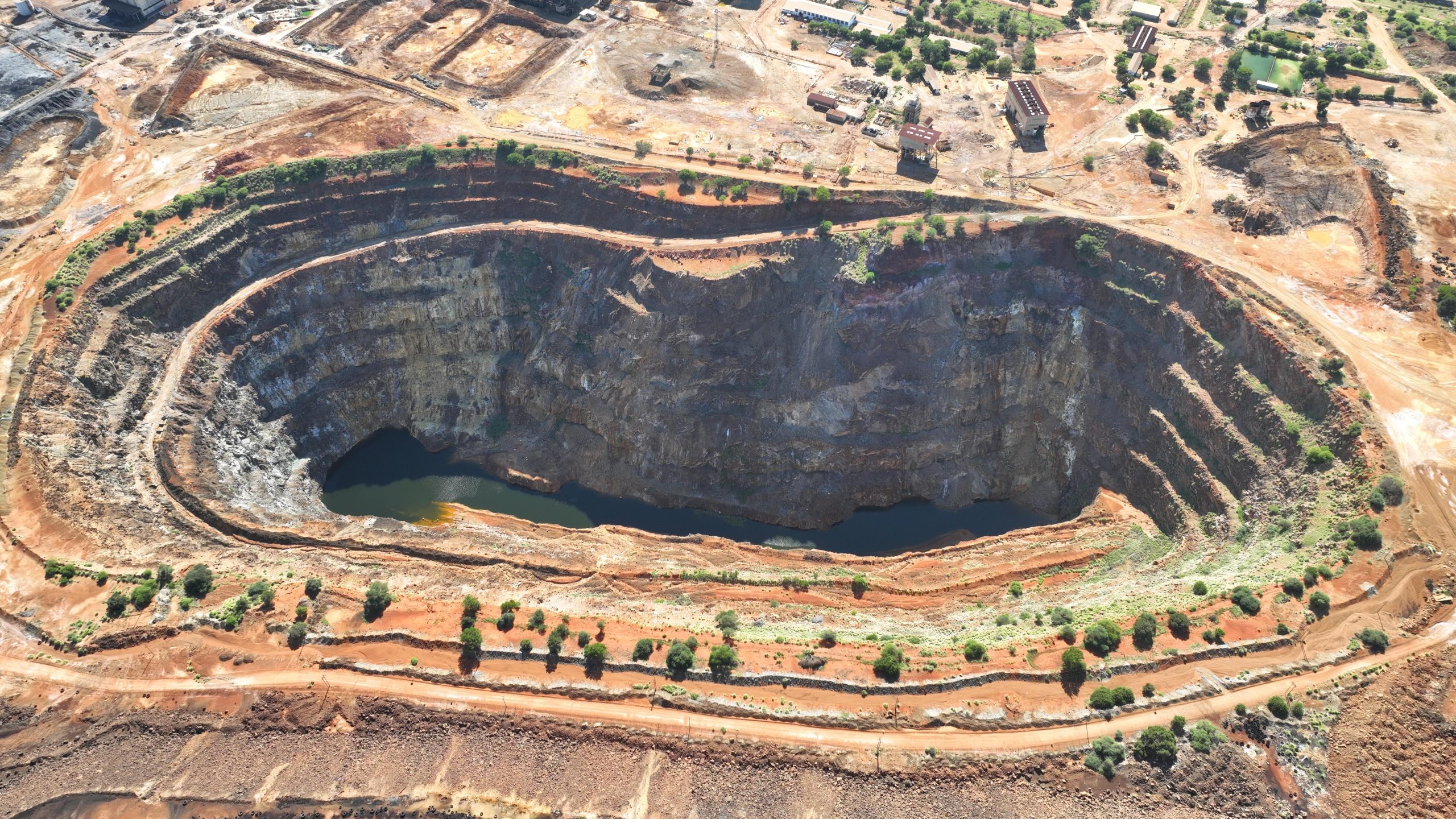 Aerial view of an open‑pit copper mine at an exploration site.
