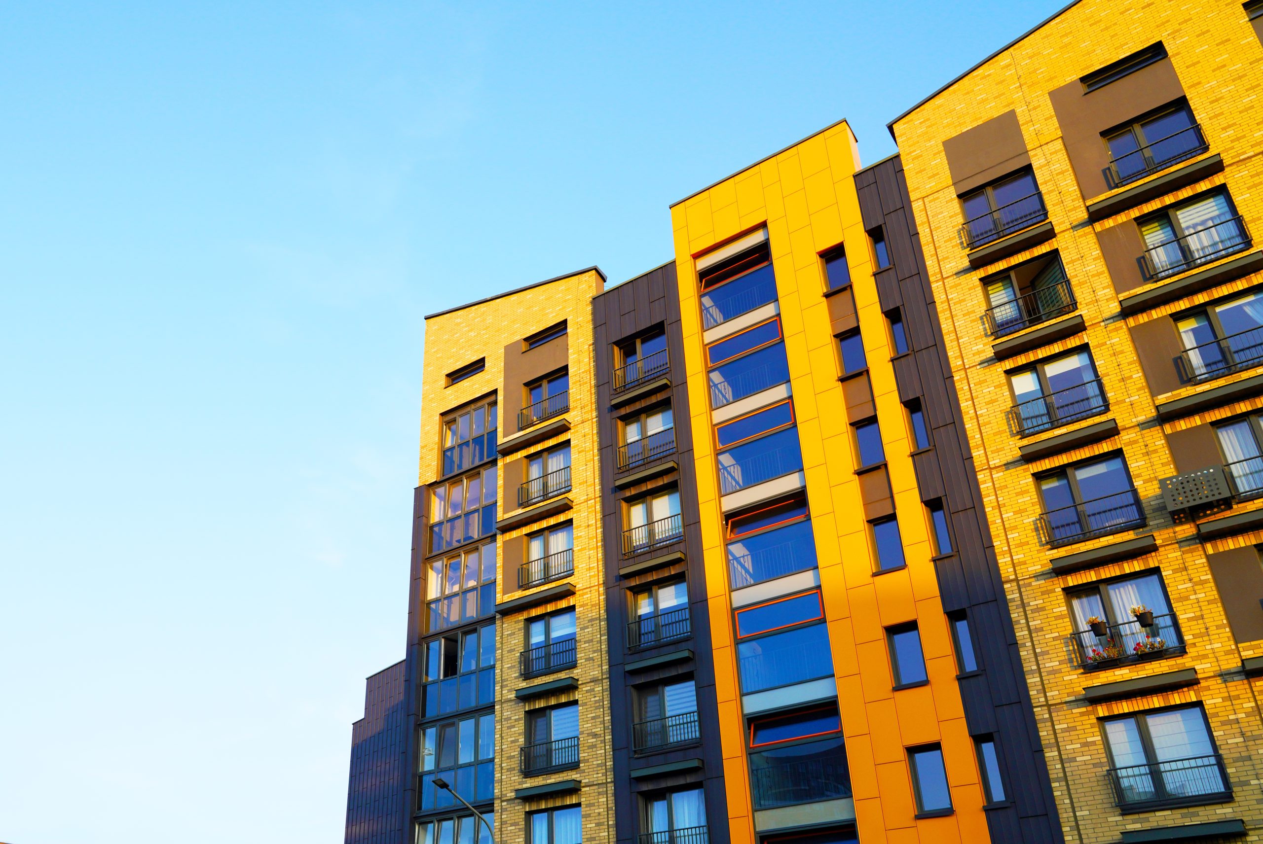 Modern apartment building facade representing structure and governance in regulated environments