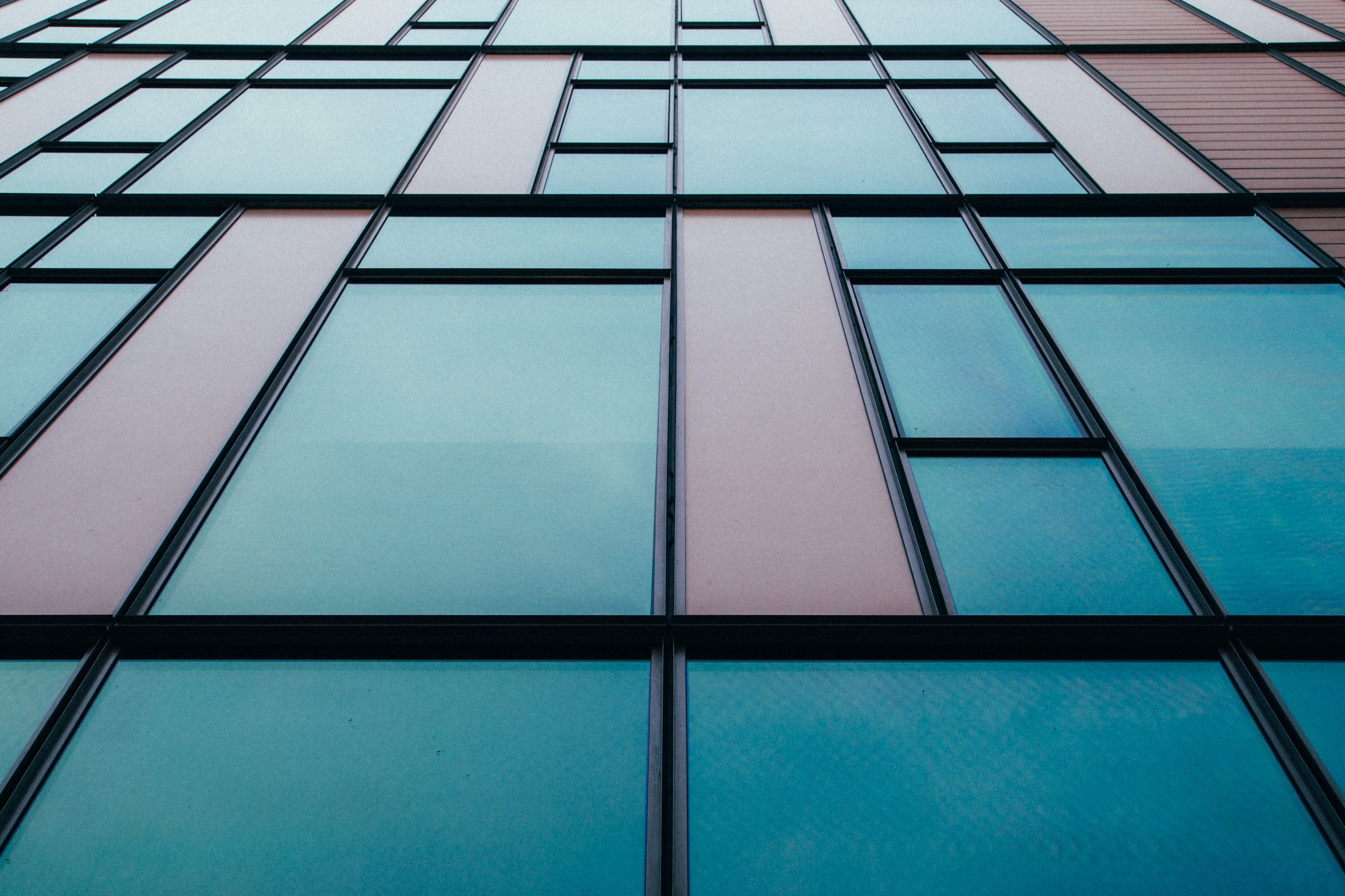 Glass office building exterior reflecting light, representing FRS 102 lease and financial reporting changes in 2026