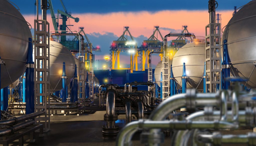 Helium production facility with industrial storage tanks and pipelines at sunset