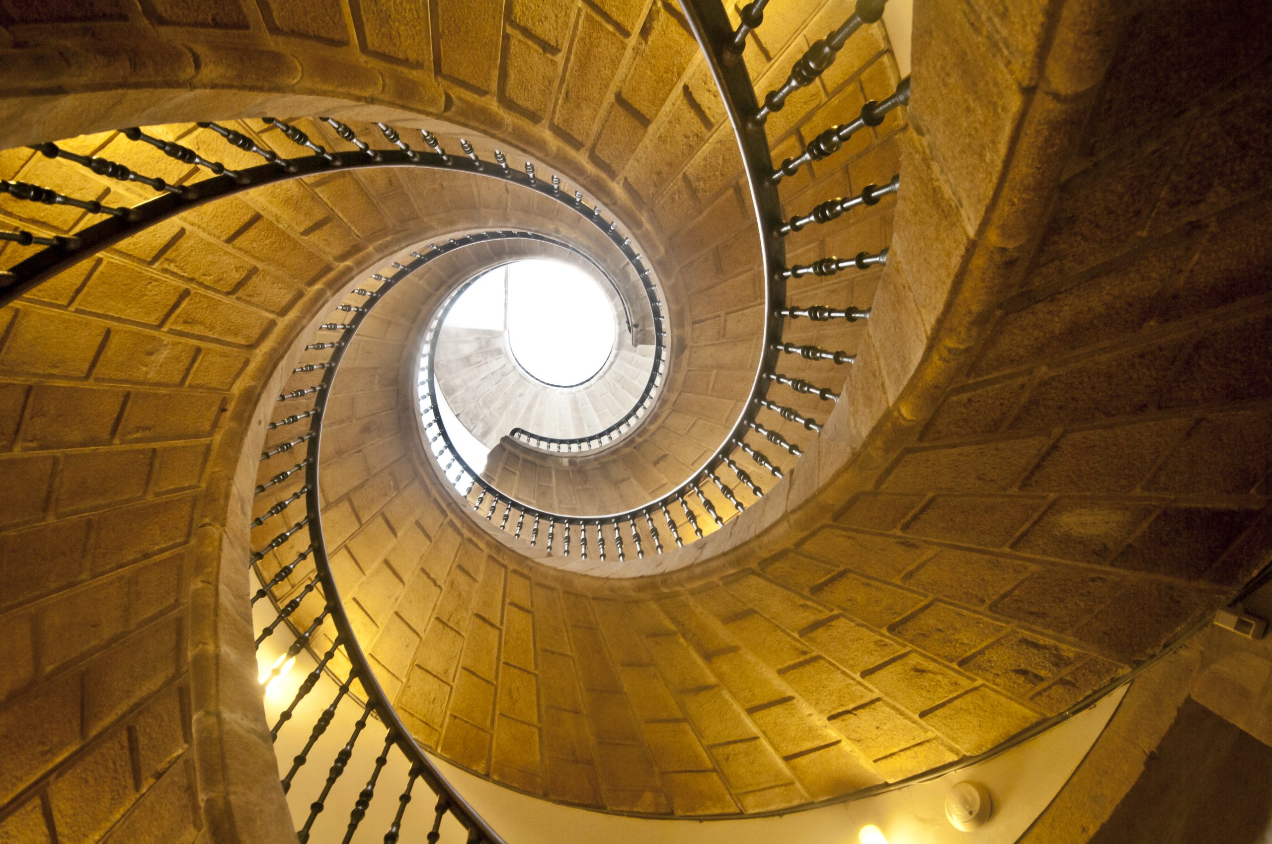 Spiral staircase symbolising the financial due diligence journey for owner-managed business sales