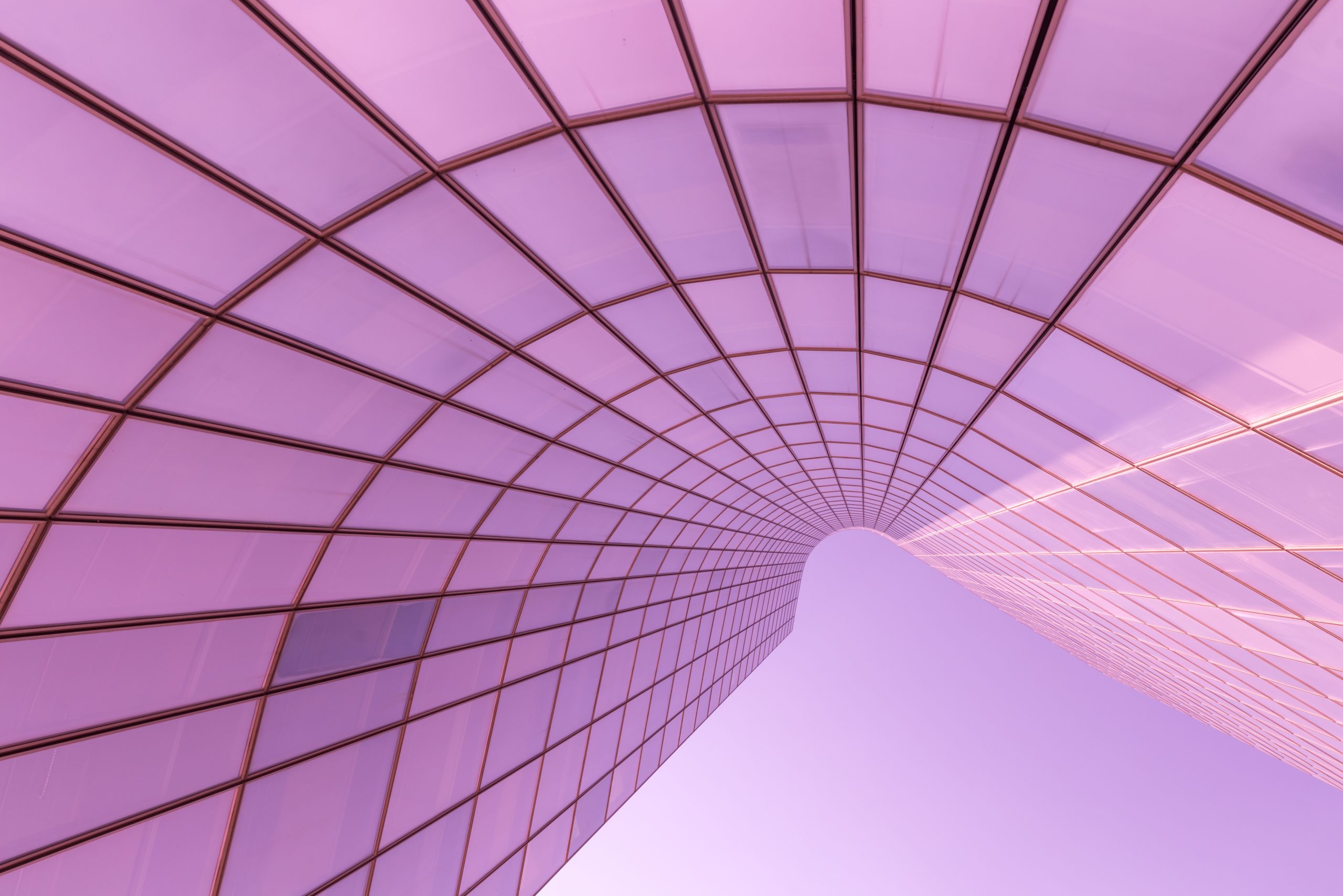 light pink Abstract curved glass building facade