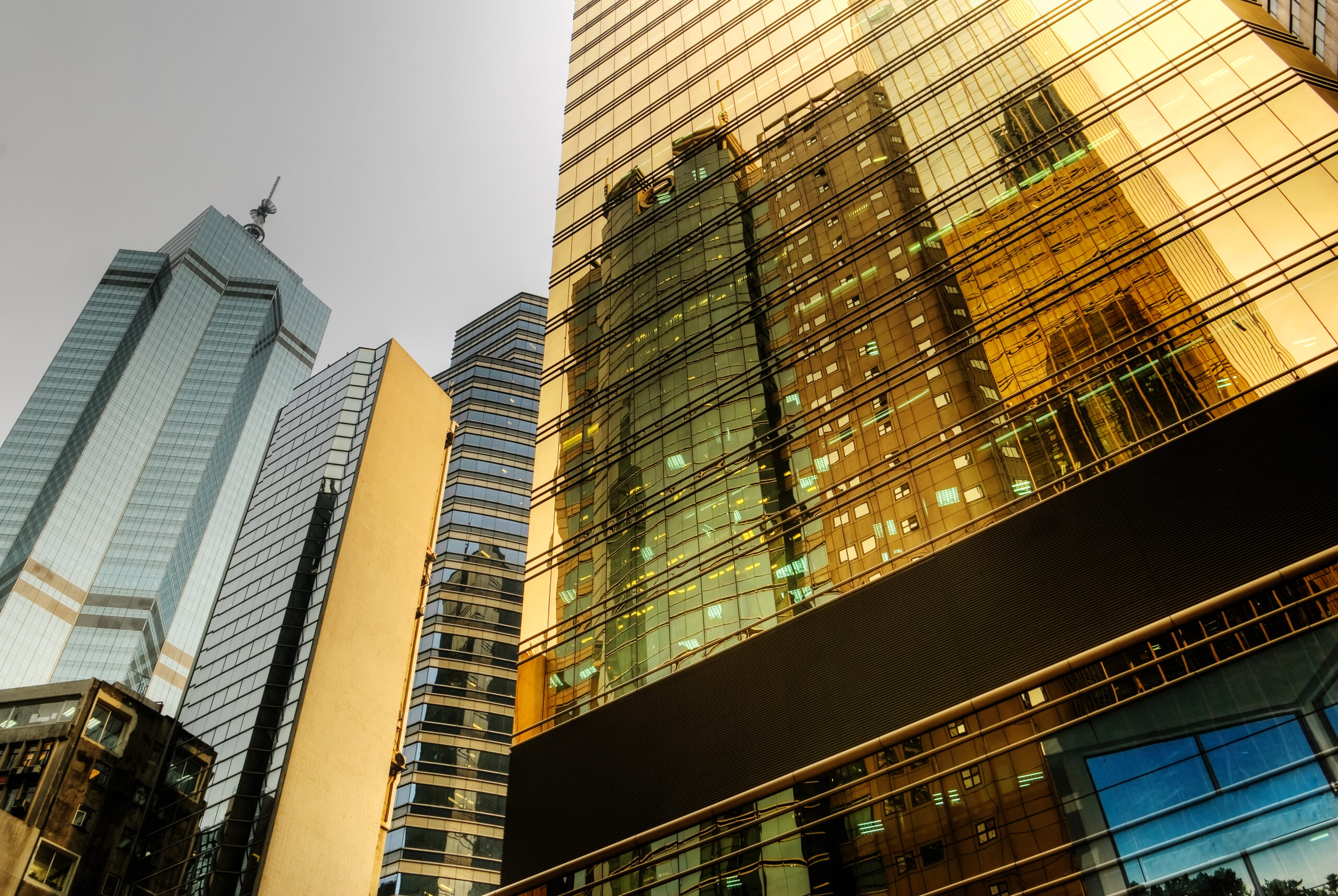 Modern office buildings reflected in glass facades within a commercial business district