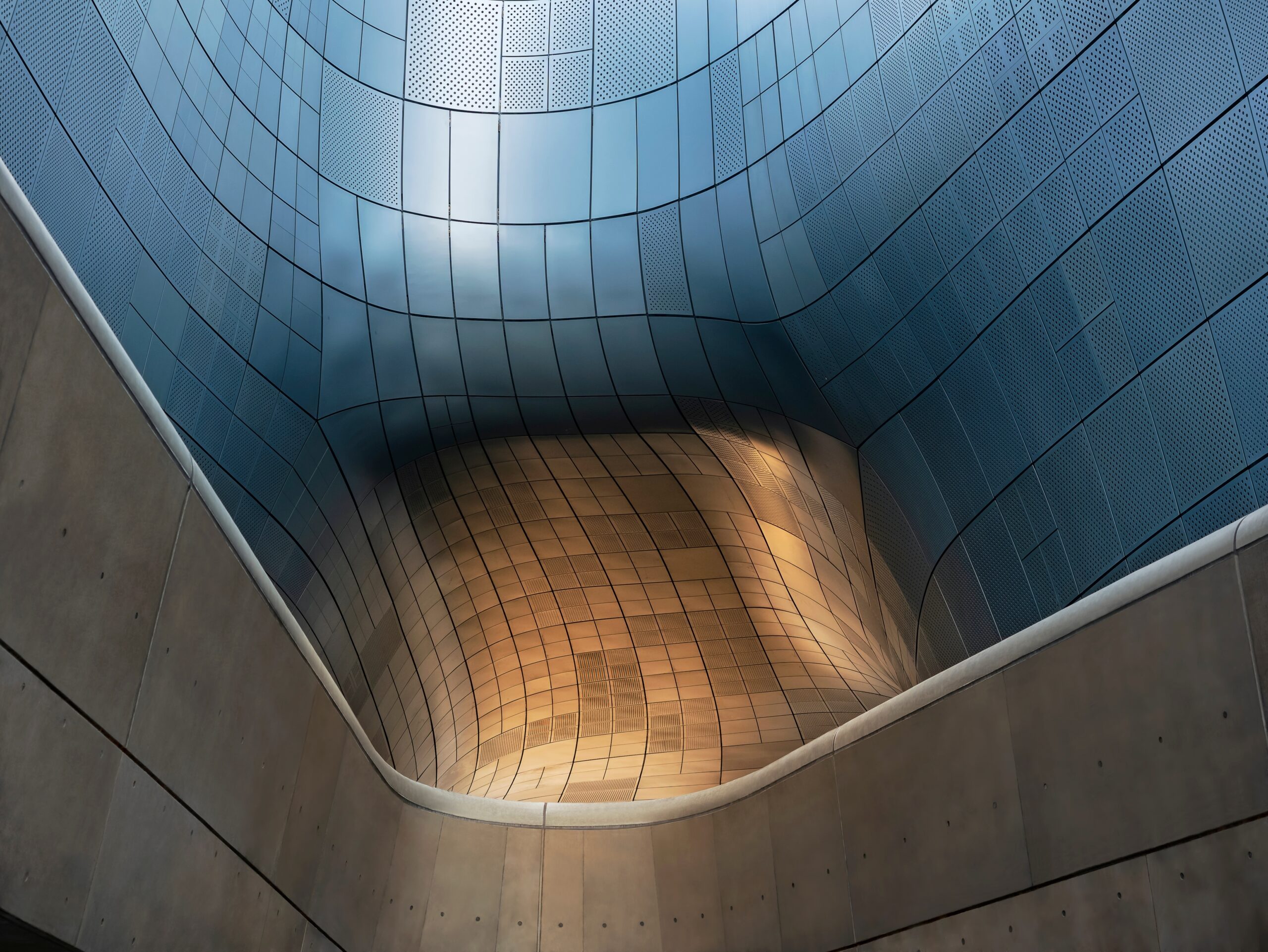 Modern curved architectural structure with metallic panels and contemporary design